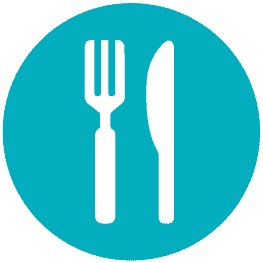 Brightly colored children's dining area at Monkey Puzzle Day Nursery Enfield, featuring child-friendly tables and chairs designed for young learners.