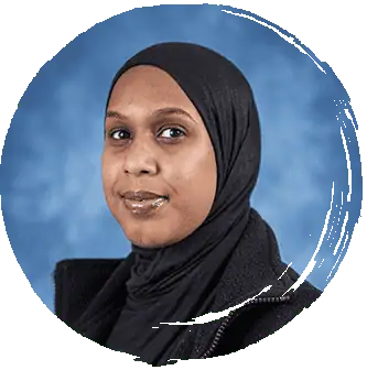 Safia Bright smiling woman wearing a black hijab against a blue background, representing the friendly and diverse environment at Monkey Puzzle Day Nursery Enfield.