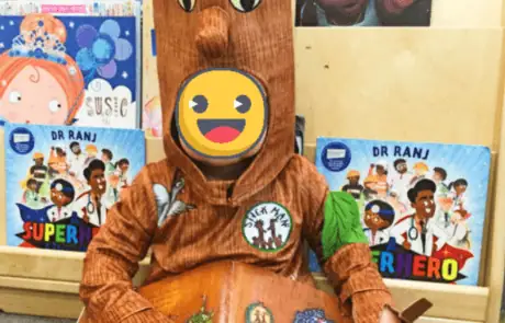 Wooden Groot and Rocket Raccoon plush toys at Monkey Puzzle Day Nursery Enfield, children's educational books about doctors and superheroes displayed on shelves, vibrant nursery setting with colorful decor and character-themed displays for early childhood learning.