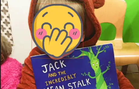 Jack holding a colorful children's book at Monkey Puzzle Day Nursery Enfield, showcasing a playful and engaging learning environment for young children.