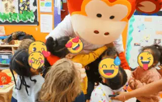 2_13637 Monkey Puzzle Day Nursery Enfield kids engaging with fun mascot for early childhood development and learning activities.