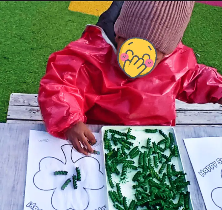 Flower craft activity at Monkey Puzzle Day Nursery Enfield, focusing on children’s creative outdoor learning and sensory play.
