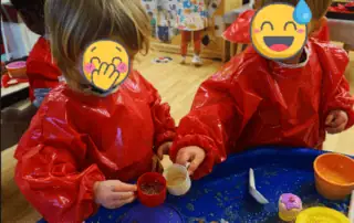 Playing children at Monkey Puzzle Day Nursery Enfield engaging in creative sensory activities with colorful toys and materials, fostering development and fun.