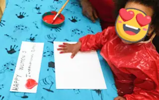 Colorful child engaging in creative arts and crafts activity at Monkey Puzzle Day Nursery Enfield, fostering early development and creativity.
