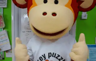 8_67770 Adorable monkey mascot at Monkey Puzzle Day Nursery Enfield, promoting a fun and nurturing environment for young children.