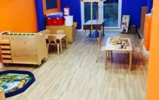 nursery rooms at monkey puzzle enfield Bright and colorful indoor play area at Monkey Puzzle Day Nursery Enfield, featuring wooden toys, children's tables, and a cozy corner perfect for early childhood development.