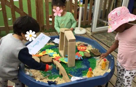 Colorful outdoor sensory play area at Monkey Puzzle Day Nursery Enfield with children engaging in creative activities and imaginative play.