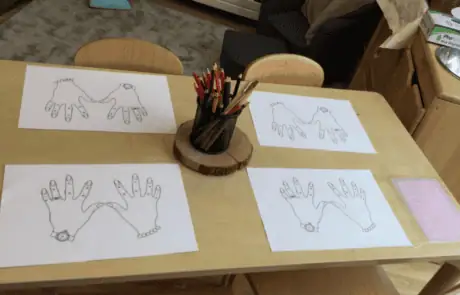 Handprint art activity at Monkey Puzzle Day Nursery Enfield, showcasing creative children's crafts and early childhood development in a nurturing nursery environment.