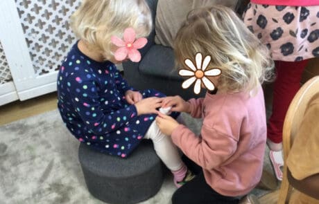 Monkey Puzzle Day Nursery Enfield children engaging in hands-on activity, fostering social skills and sensory development in a safe, nurturing environment.