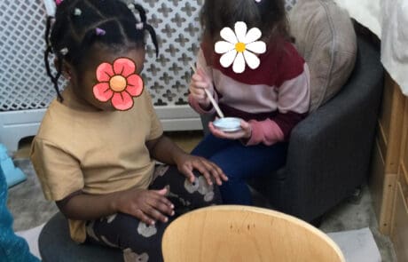 British nursery children enjoying snack time at Monkey Puzzle Day Nursery Enfield, fostering social interaction and early learning.
