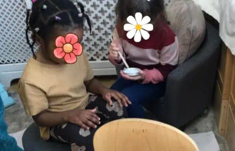British nursery children enjoying snack time at Monkey Puzzle Day Nursery Enfield, fostering social interaction and early learning.
