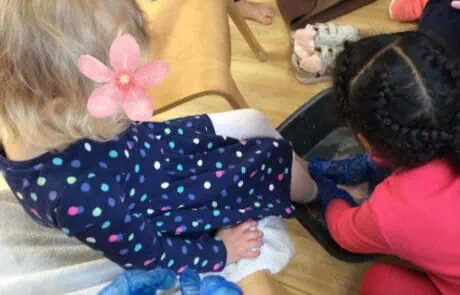 Helping children with activities at Monkey Puzzle Day Nursery Enfield in a caring preschool environment.