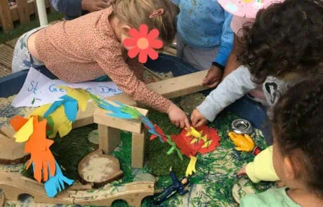 Children engaging in imaginative play with colorful animal and nature-themed toys at Monkey Puzzle Day Nursery Enfield, fostering creativity and social development.