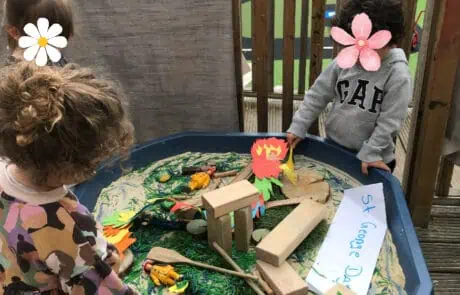 Sandbox play area with children exploring sensory and creative activities at Monkey Puzzle Day Nursery Enfield.