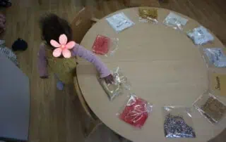 Colorful sensory activity with children at Monkey Puzzle Day Nursery Enfield, engaging young learners in hands-on exploration of textures and materials.