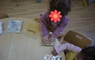 Colorful preschool children engaging in sensory play activities at Monkey Puzzle Day Nursery Enfield, fostering early childhood development in a caring environment.
