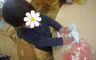 Delighted young girl engaging in arts and crafts at Monkey Puzzle Day Nursery Enfield, with colorful materials and a warm learning environment, perfect for early childhood development and creative play.
