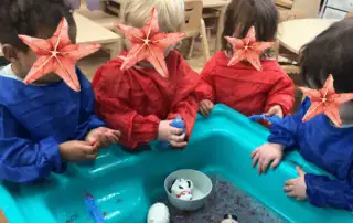 Flocked-babies-playing-with-sensory-activities-in-day-nursery.