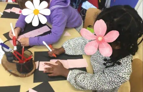 Pink paper craft activity at Monkey Puzzle Day Nursery Enfield with children engaging in creative arts and crafts.