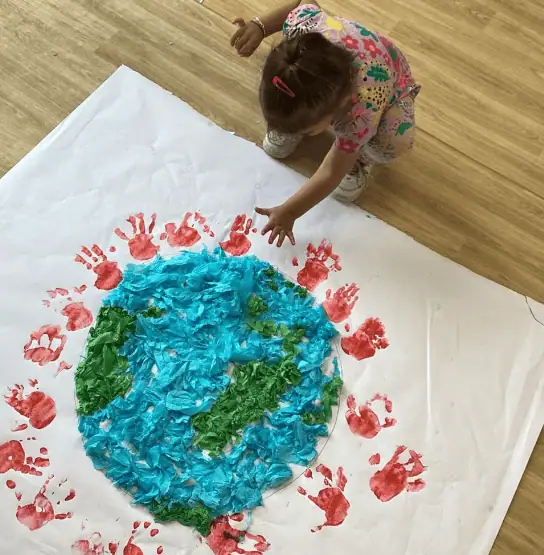 Colorful Earth art project created by a young child at Monkey Puzzle Day Nursery Enfield, focusing on creativity and environmental awareness.
