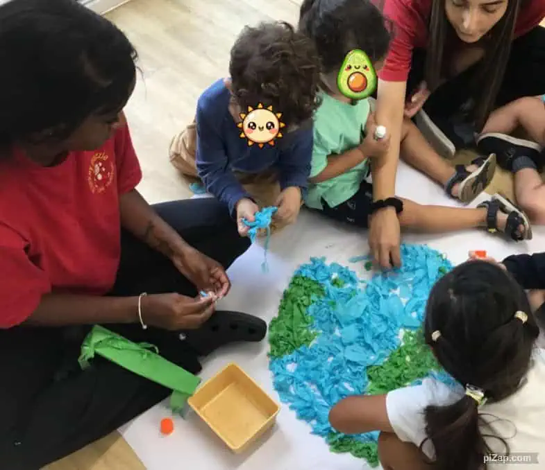 Colorful children engaged in sensory art activity at Monkey Puzzle Day Nursery Enfield, fostering creativity and social skills.
