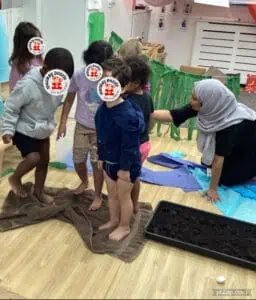 Children engaging in sensory play activity at Monkey Puzzle Day Nursery Enfield, fostering early childhood development and learning.