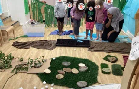 Kids engaging in sensory play at Monkey Puzzle Day Nursery Enfield, featuring natural materials and interactive learning activities for early childhood development.