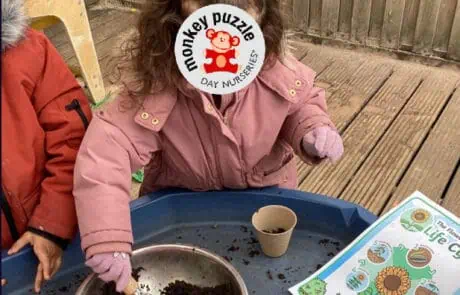 Freshly prepared outdoor soil sensory activity for children at Monkey Puzzle Day Nursery Enfield, fostering early childhood development and outdoor play skills.