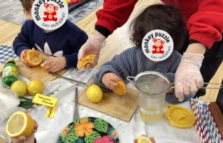 Lemon slicing activity at Monkey Puzzle Day Nursery Enfield, focusing on early childhood development and engaging sensory experiences for young children.