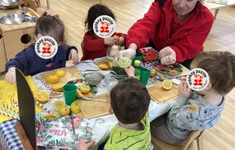 Freshly prepared fruit snack activity at Monkey Puzzle Day Nursery Enfield, engaging young children in healthy eating and social interaction.