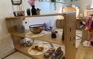 Monkey Puzzle Enfield Environment Wooden play kitchen and toy food setup at Monkey Puzzle Day Nursery Enfield, providing a nurturing environment for early childhood development and imaginative play.
