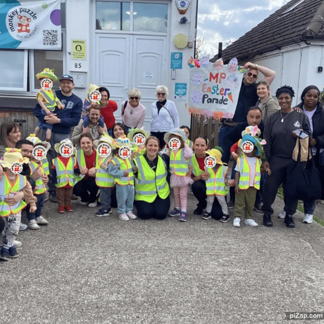 Brightly dressed children and staff celebrating Easter Parade outside Monkey Puzzle Day Nursery Enfield, showcasing fun nursery activities and community engagement for early childhood development.