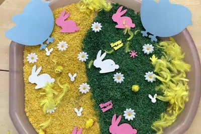 Vibrant Easter-themed craft with colorful bunny and flower decorations for early childhood education at Monkey Puzzle Day Nursery Enfield.