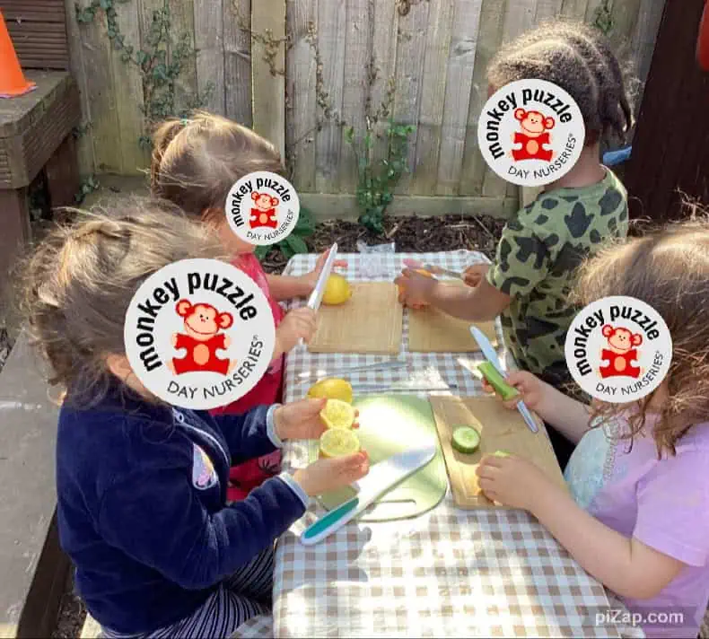 Freshly prepared healthy snacks such as lemons and cucumbers enjoyed outdoors at Monkey Puzzle Day Nursery in Enfield, fostering healthy eating habits among young children.