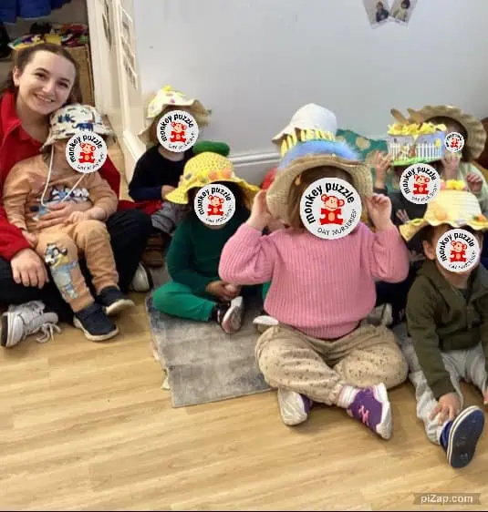 Tiny team of children at Monkey Puzzle Day Nursery Enfield, wearing colorful hats and engaging in fun, educational activities, showcasing a vibrant and nurturing environment for early childhood development.