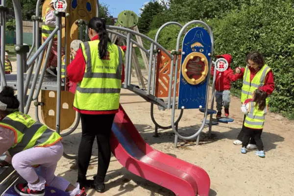 Climbing on outdoor playground equipment at Monkey Puzzle Day Nursery Enfield, children enjoying active play in a safe, supervised environment.