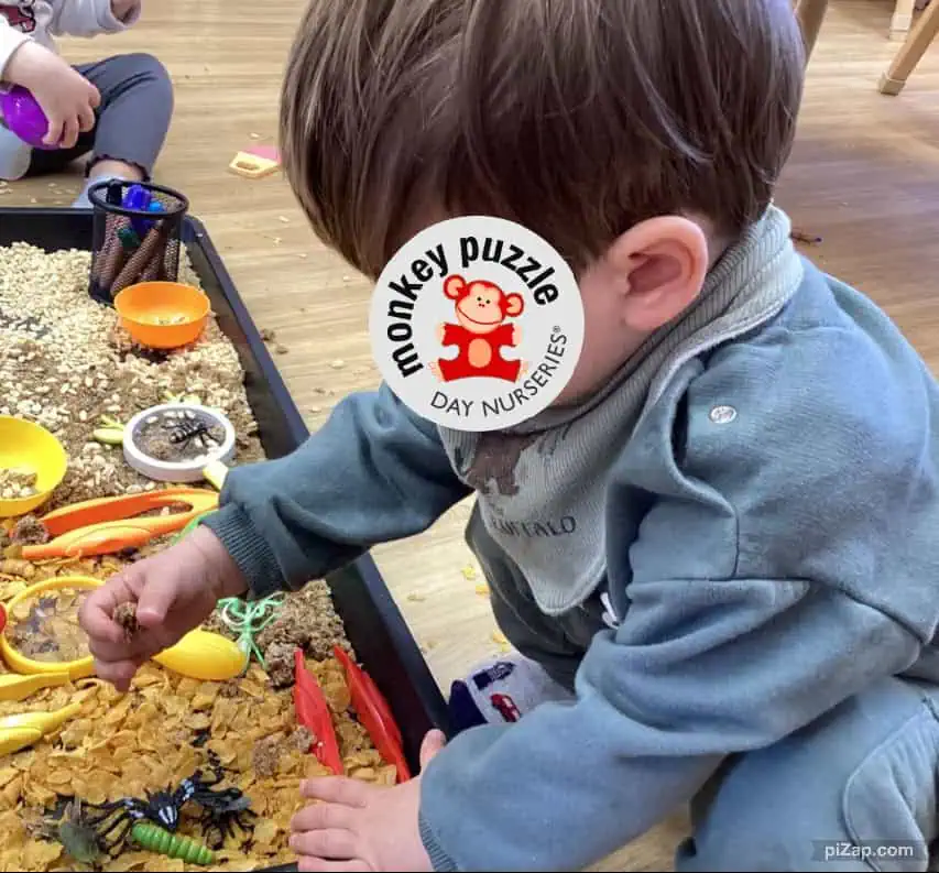 Soil sensory play for children at Monkey Puzzle Day Nursery Enfield with kids exploring insects and natural textures in a safe indoor environment.