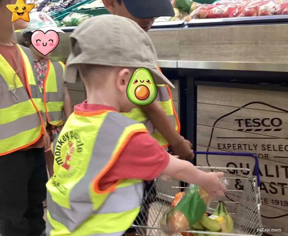 Grocery shopping for children at Tesco supermarket, kids wearing high visibility vests, young children shopping for fresh produce, supermarket shopping with children, outdoor shopping activity for kids at Tesco store.