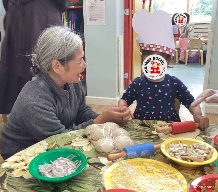 Chicken cooking activity at Monkey Puzzle Day Nursery Enfield with children and staff engaging in a fun, educational cooking session.