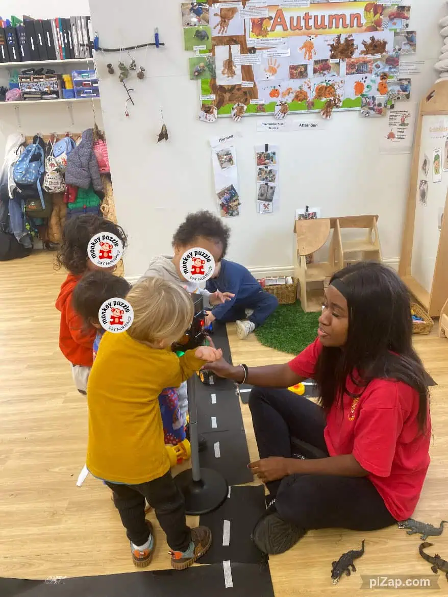 Kids engaging in a role-play activity about autumn with a teacher at Monkey Puzzle Day Nursery Enfield, fostering creativity and social skills.