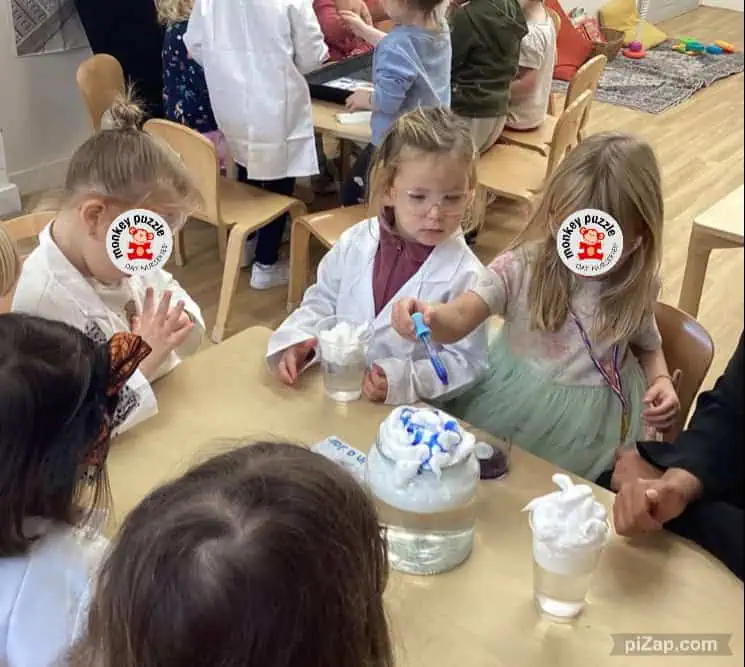 - playful children engaging in hands-on science activity at Monkey Puzzle Day Nursery Enfield, promoting early learning and curiosity.