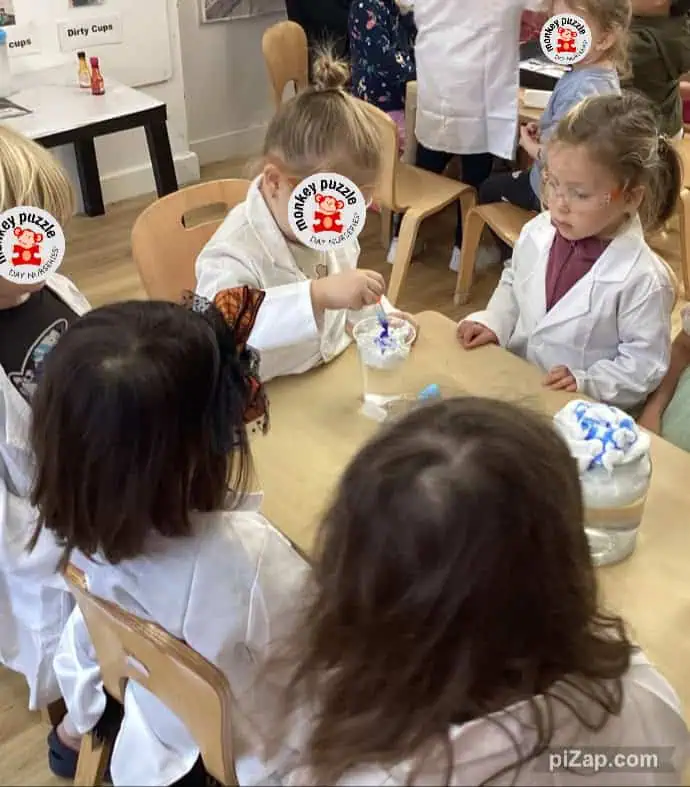 Playful children engaging in arts and crafts activity at Monkey Puzzle Day Nursery Enfield, showcasing a nurturing learning environment for early childhood development in Enfield, UK.